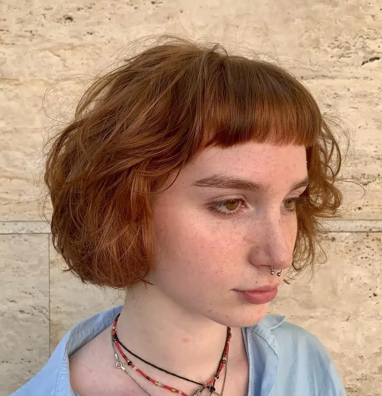 24 Short Hairstyles to Keep Your Look on Trend in 2026 19 Wavy bob paired with delicate micro bangs
