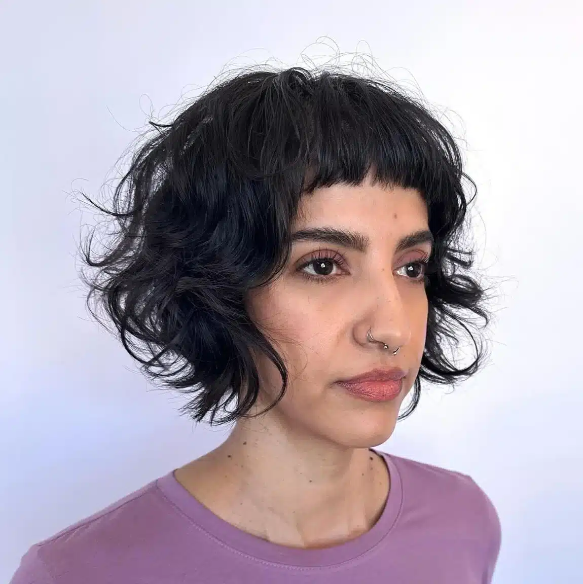 24 Short Hairstyles to Keep Your Look on Trend in 2026 3 Model wearing a short wavy French bob with micro bangs