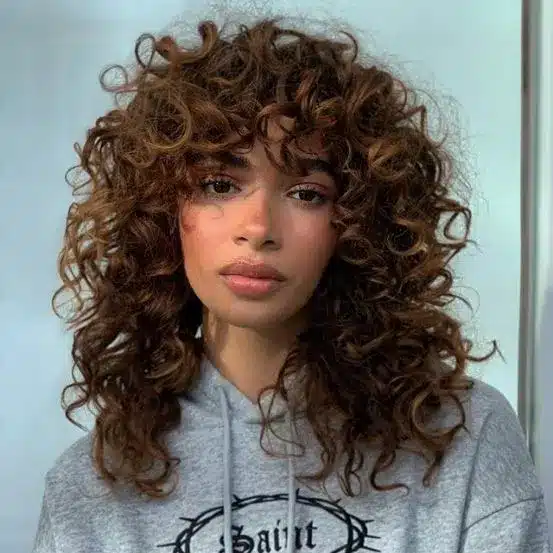 Curly Bangs framing the face with soft waves