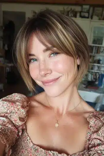 Dimensional highlighted bixie with fringe showing 31 Bixie Haircuts That Perfectly Blend Bob and Pixie Hairstyles