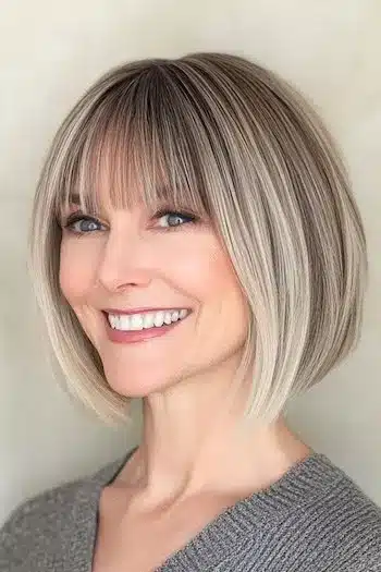 Wispy bob with bangs for fine hair on a smiling woman