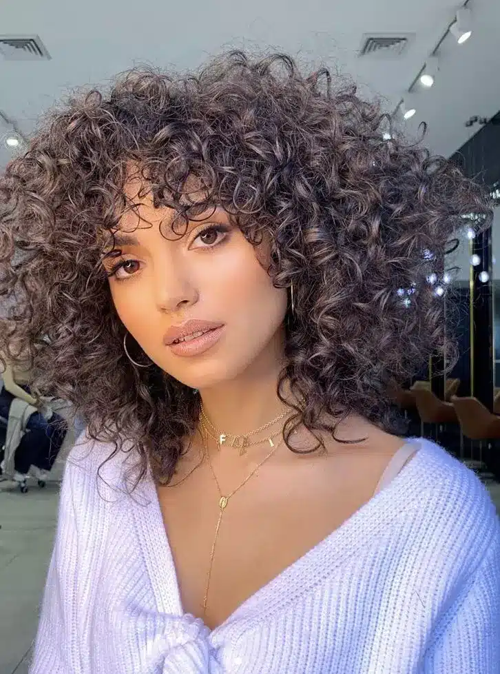 35 Short Brown Hairstyles You'll Be Seeing Everywhere 8 Curly Shoulder Shag