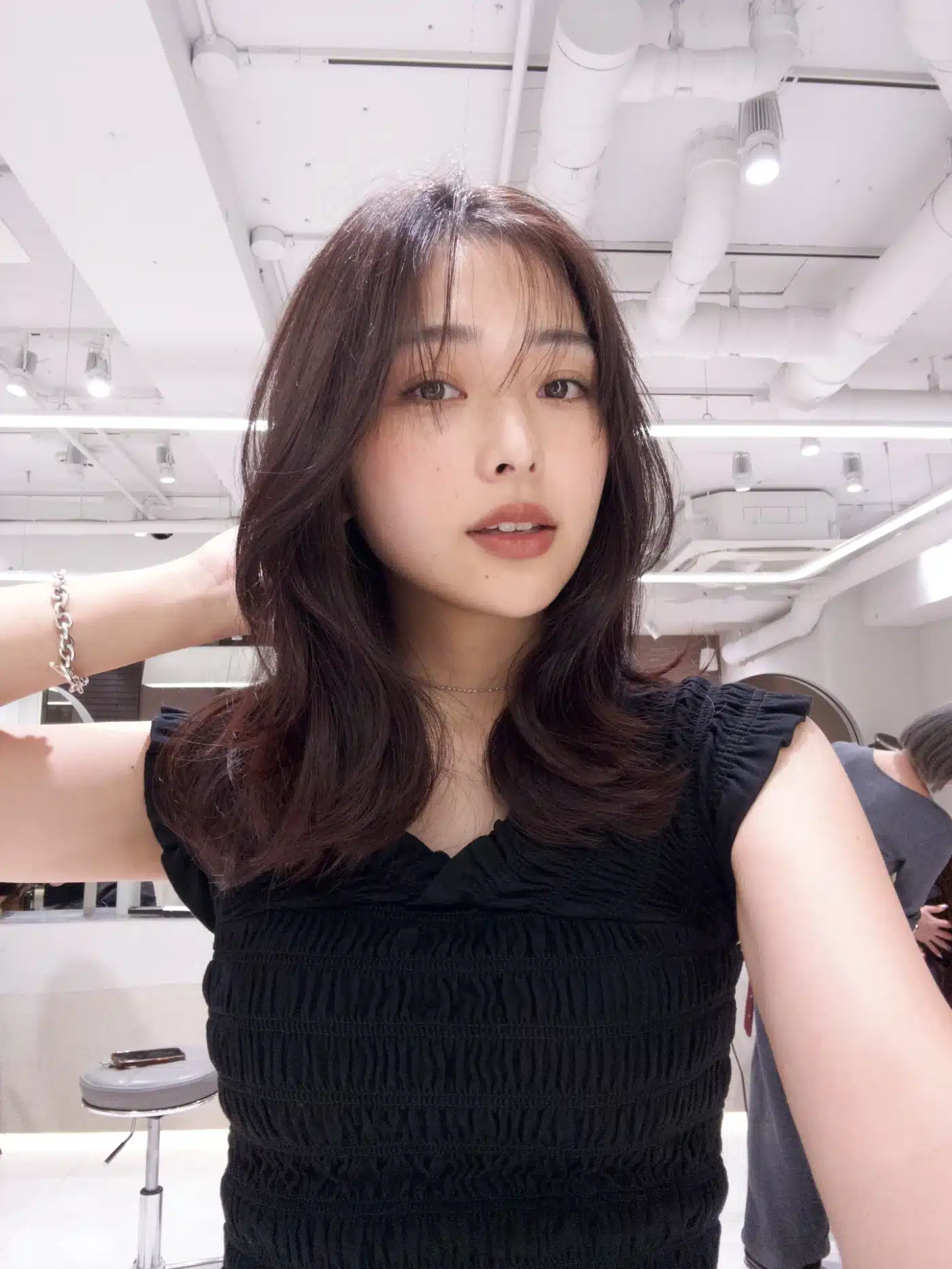 50 Low-Maintenance Medium-Length Haircuts for Busy Women 7 Mid-Length Layered Cut with Light Curtain Bangs and Feathered Ends