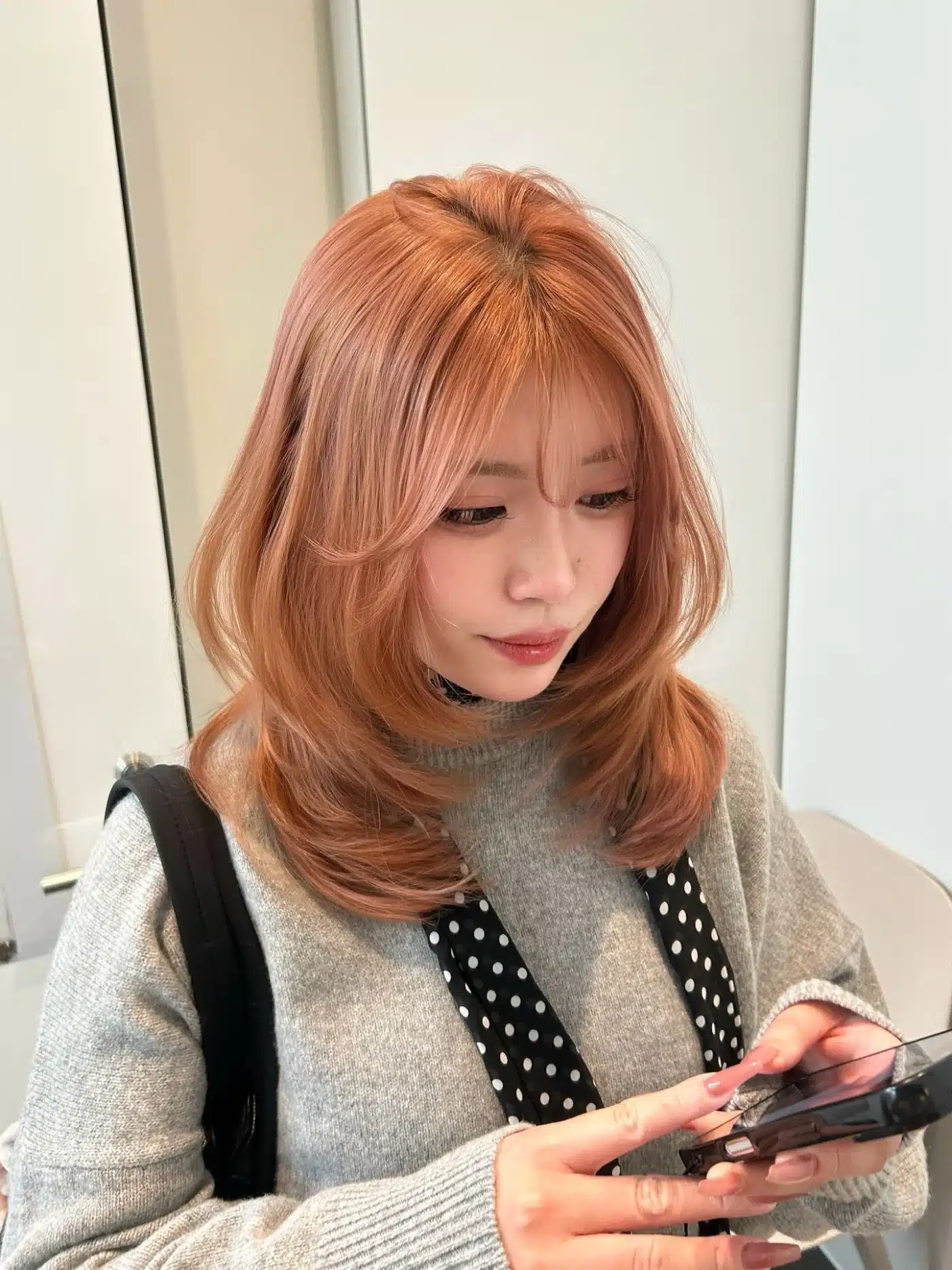 50 Low-Maintenance Medium-Length Haircuts for Busy Women 9 Rose-Gold Feathered Medium Cut with Soft Curtain Fringe