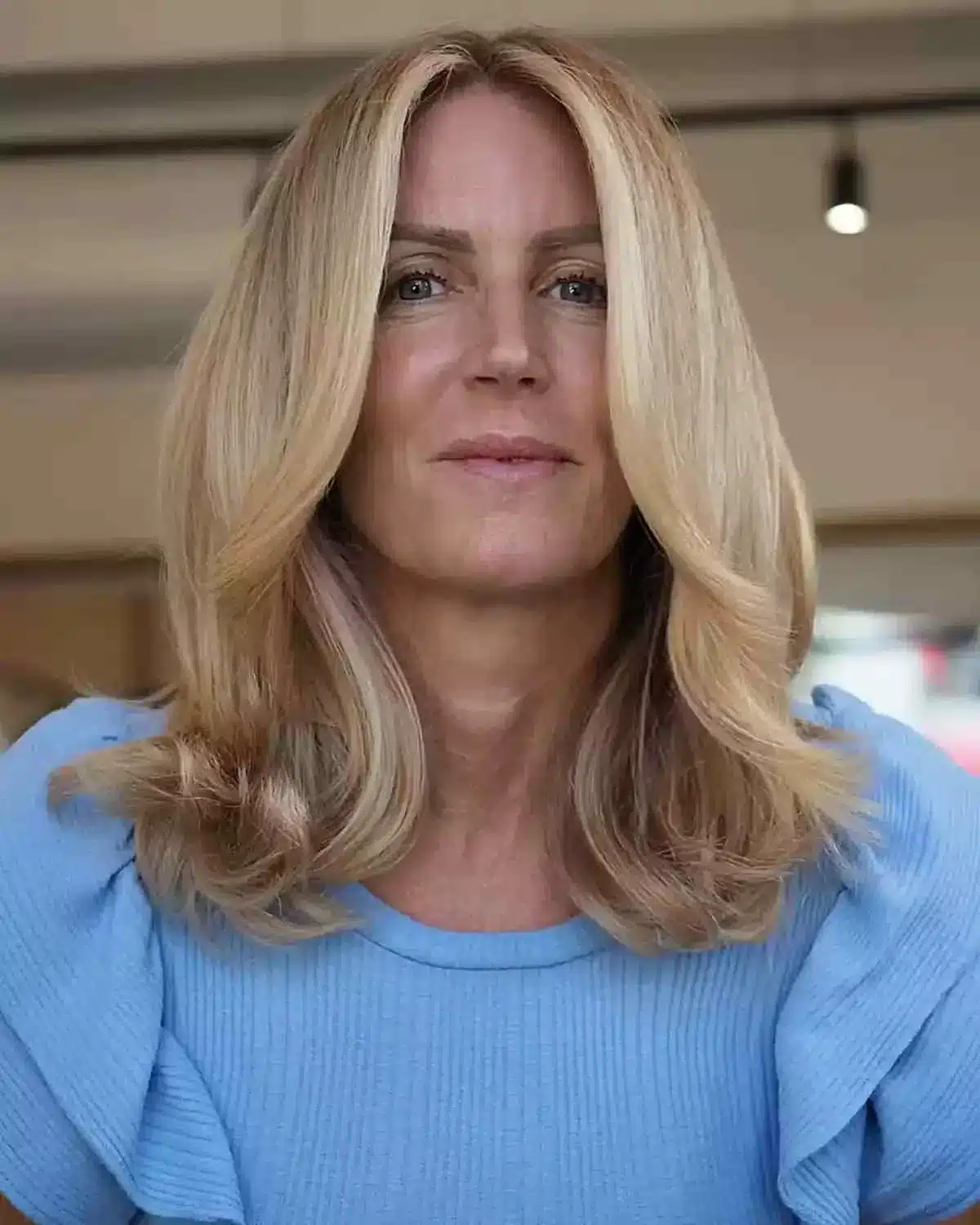 50 Low-Maintenance Medium-Length Haircuts for Busy Women 24 Face-Framing Long Curtain Bangs on Blonde Mid-Length Hair for a Low-Maintenance Style